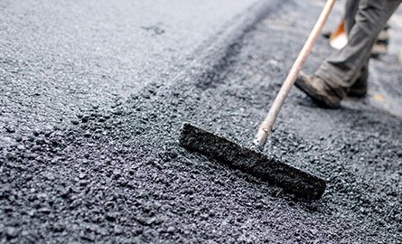 Person paving with asphalt